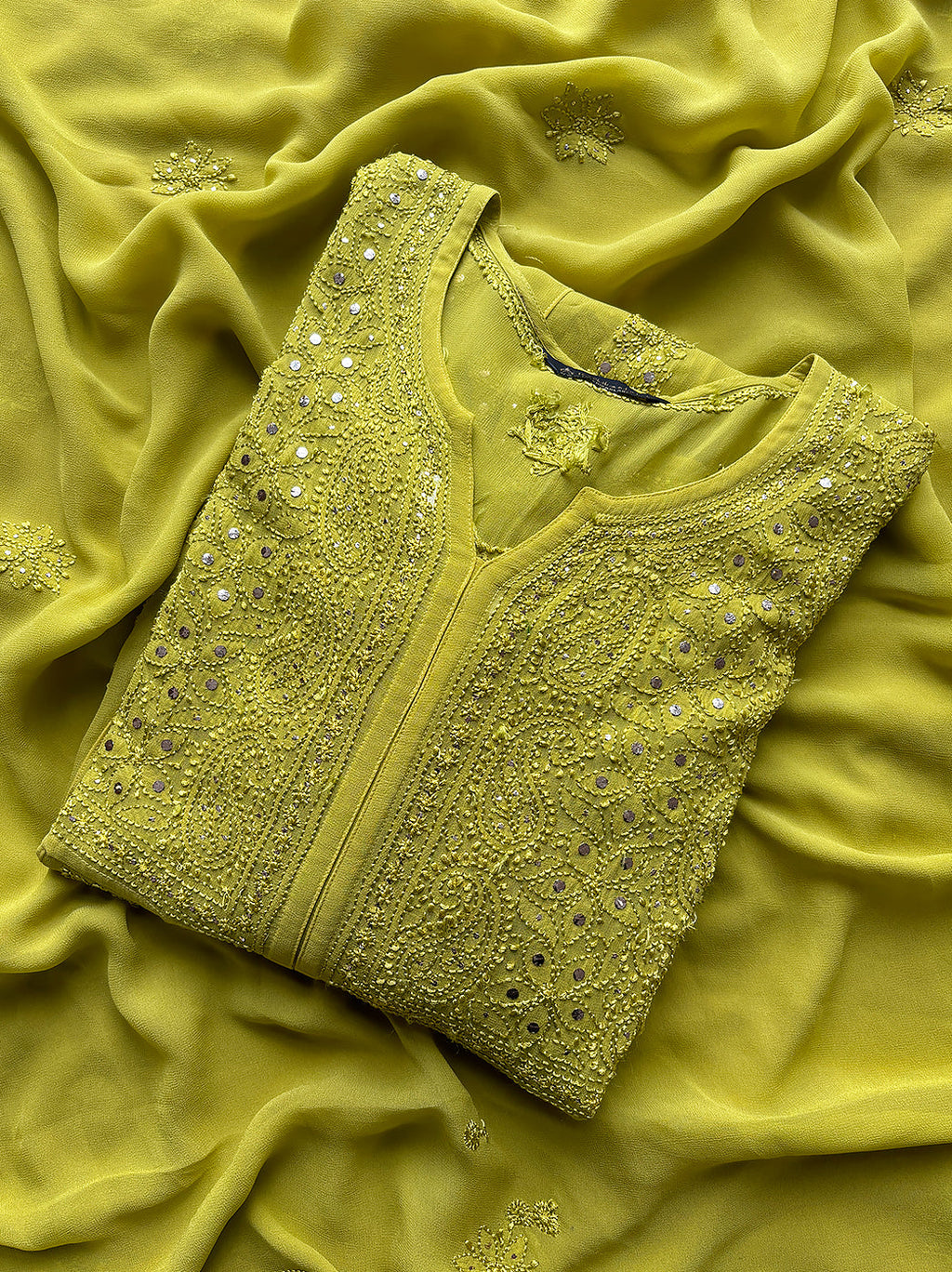 Folded lime green chikankari kurta with mirror work