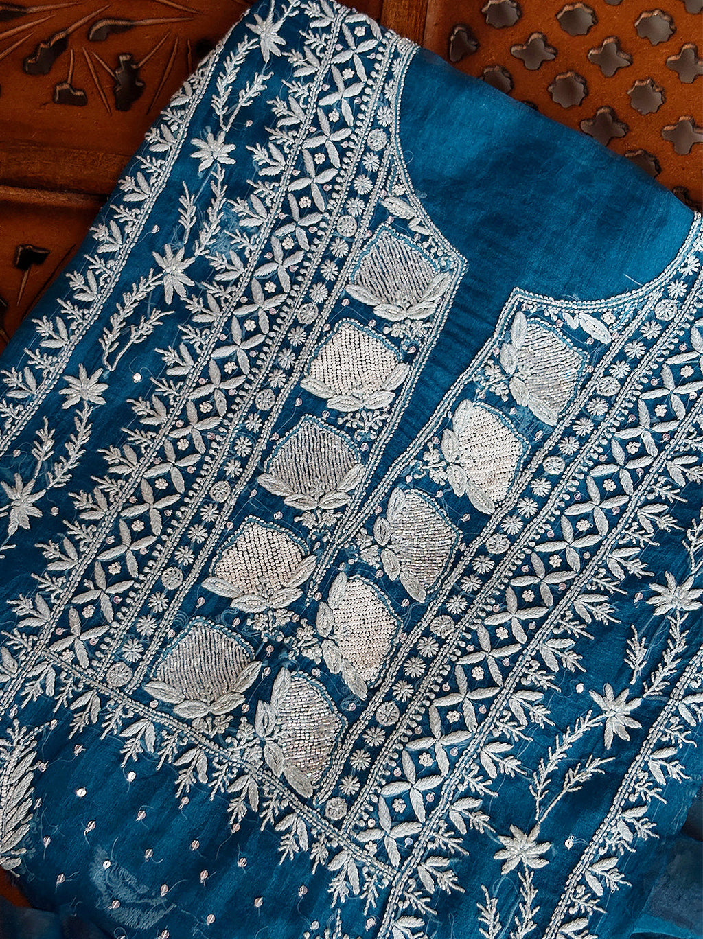 Traditional chikankari kurti piece in organza fabric paired with an embroidered dupatta.