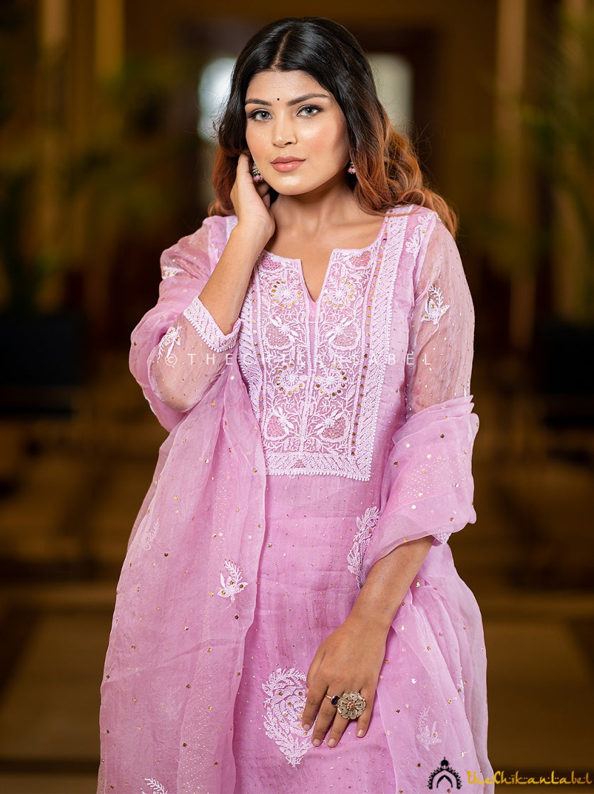 “Model wearing stitched chikankari kurti set in organza with matching embroidered dupatta and pant”